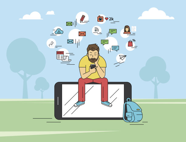 一个年轻人坐在公园里发短信图片下载