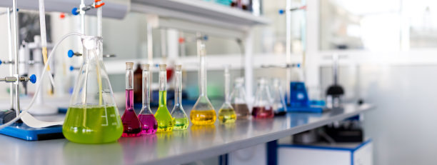 实验室桌子上堆满了彩色液体图片下载