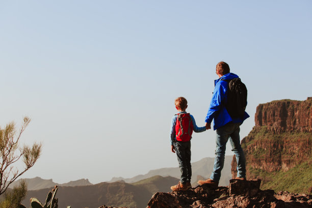父子俩在风景优美的山上远足图片下载