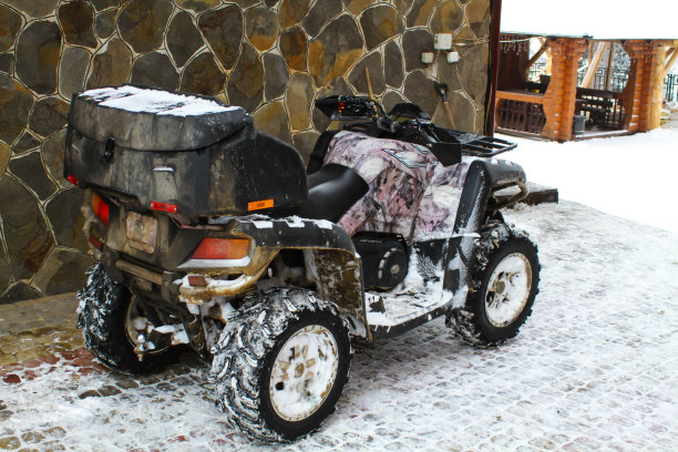 冬天骑四轮摩托车。ATV车轮和履带。图片下载