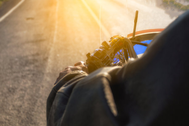 在道路上驾驶时的摩托车把手特写图片下载