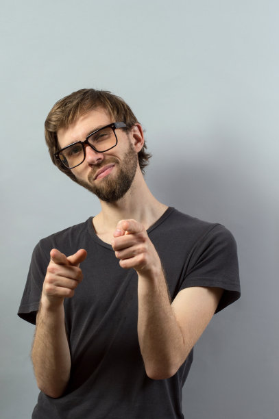 一个随意的年轻人指着相机的搞笑图片图片下载