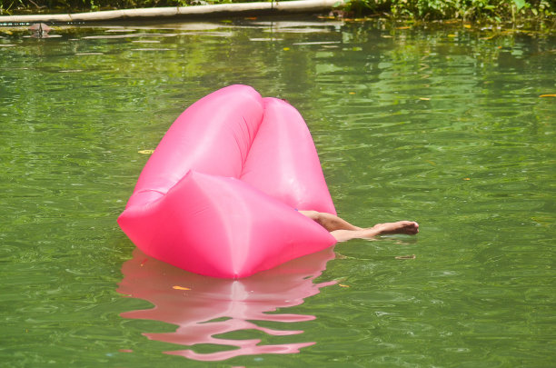 粉色充气床浮在水上照片图片下载