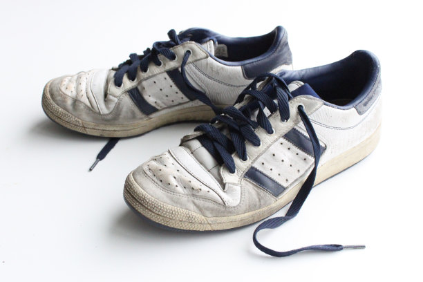 一双破旧的白色老式运动鞋图片下载