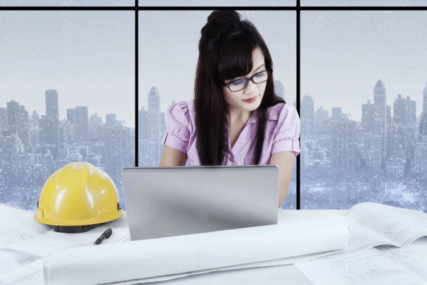 带着笔记本电脑和蓝图的年轻建筑师图片下载