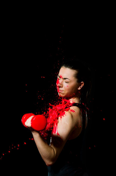 运动女孩拿着哑铃在二头肌上锻炼图片下载