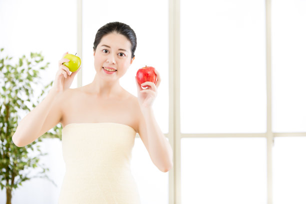 美丽的亚洲女孩在浴巾和新鲜的苹果水疗图片下载