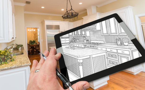 手在电脑板上显示厨房照片背后的图画。图片下载