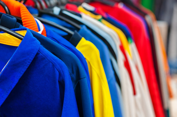 商店里有很多色彩鲜艳的衣服挂在衣架上图片下载