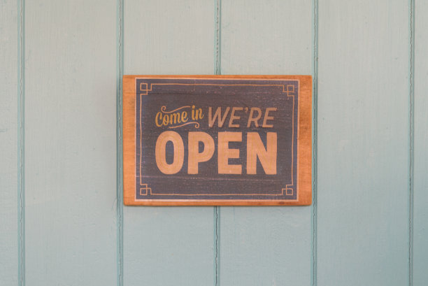 蓝色木门上有“打开”字样的棕色木制古董标志图片下载