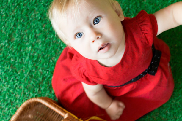 可爱的小女孩穿着红色连衣裙抬头看图片下载