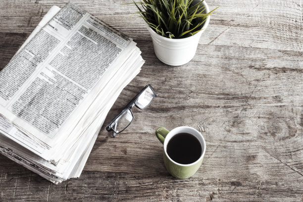 报纸放在木桌上图片下载