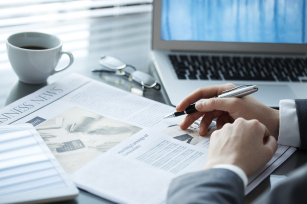 女商人在工作台上看报纸图片下载