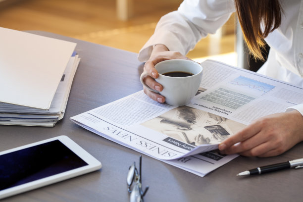 女人在桌子上看报纸图片下载