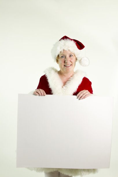 圣诞老人拿着空白的白色标志图片下载