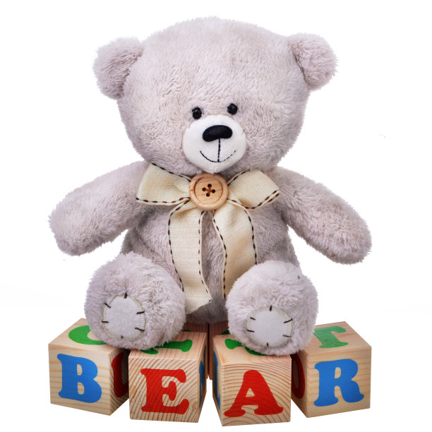 柔软的泰迪熊坐在木制立方体上图片下载