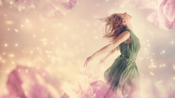 美丽的女人在一朵粉红色的牡丹花素材图片