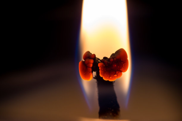 一个燃烧的蜡烛芯的宏。图片下载