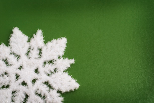 白色的雪花在绿色的背景图片下载