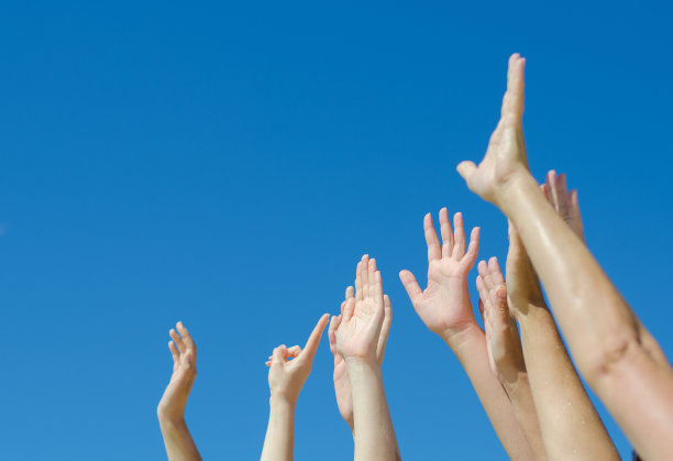 蓝天下举起了许多手。图片下载