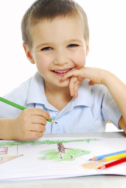 快乐的小男孩用彩色铅笔涂色图片下载