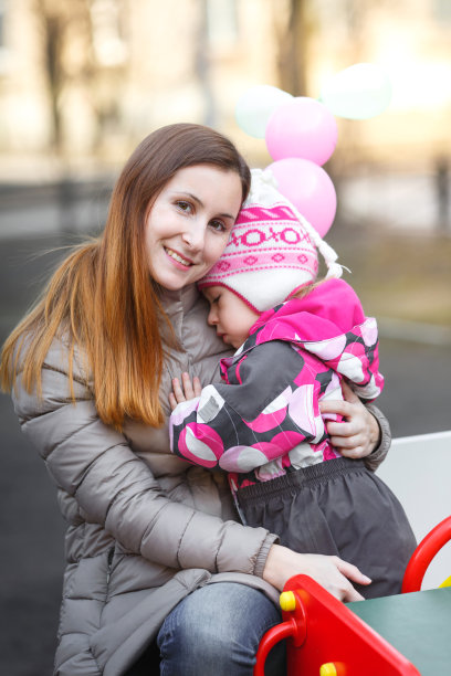 妈妈和女儿依偎在公园的长椅上图片下载