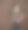 戴眼镜在棕色墙壁前微笑的女人图片下载