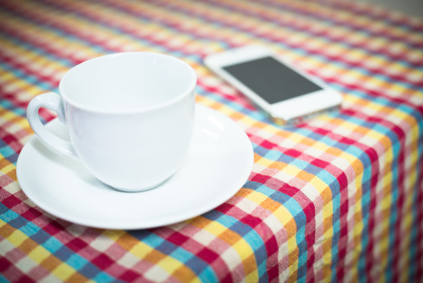 桌上放着一杯茶和手机图片下载