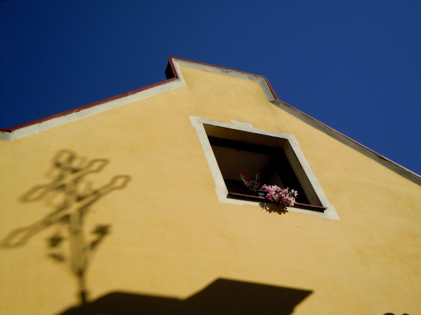 黄色房子的窗户和教堂的十字架的影子图片下载