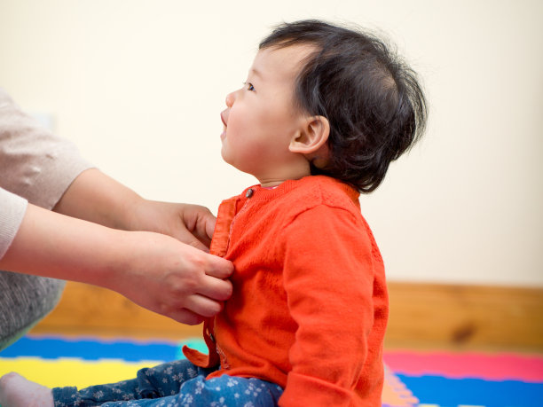 妈妈给她的小女儿穿衣服图片下载