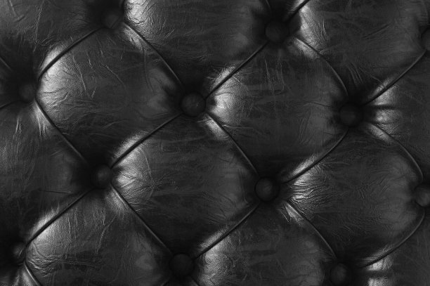 黑色钮扣皮革纹理。图片下载