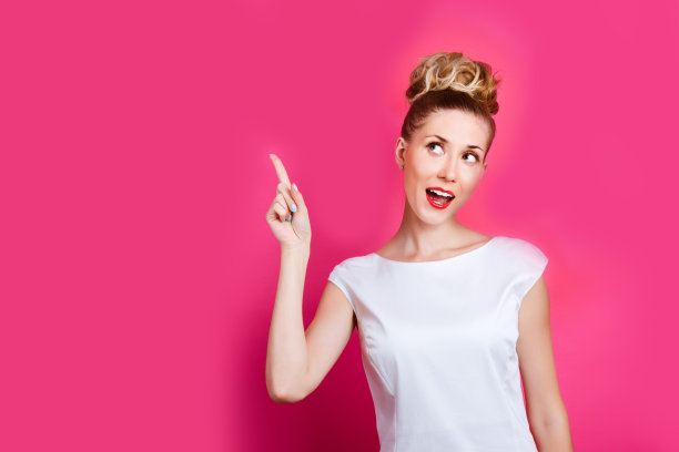 漂亮的女人在亮粉色的墙背景概念图片下载