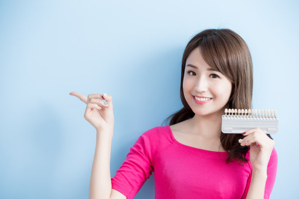 女人手持牙齿美白工具素材图片