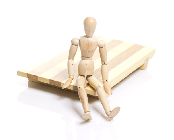 木制假人坐在日式寿司盘上。图片下载