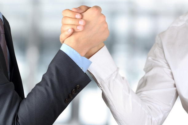两个商人在一个向前的背景上互相握手图片下载