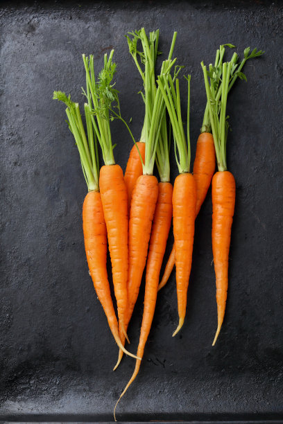 黑色背景上的有机胡萝卜图片下载