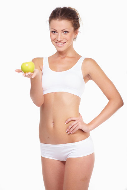 年轻美丽的女子，绿苹果孤立在白色的背图片下载