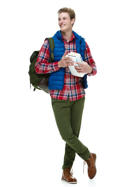 微笑的男学生拿着书看向别处图片下载