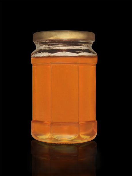 有黑色背景的蜂蜜罐图片下载