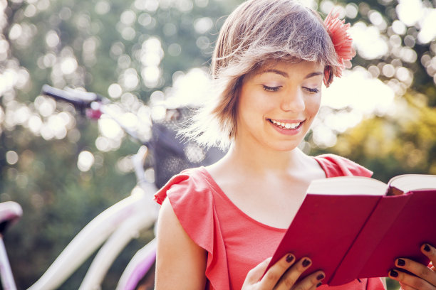 美丽的乡村女孩在大自然中读书。图片下载