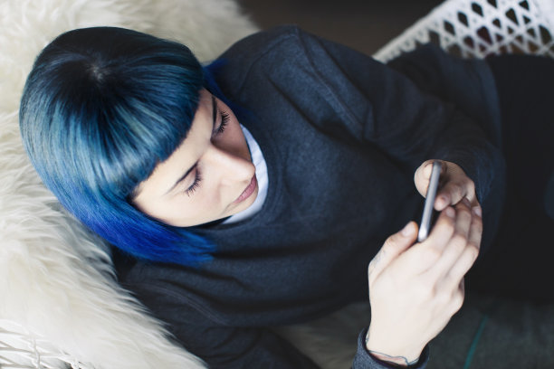 年轻女子在家里使用智能手机图片下载