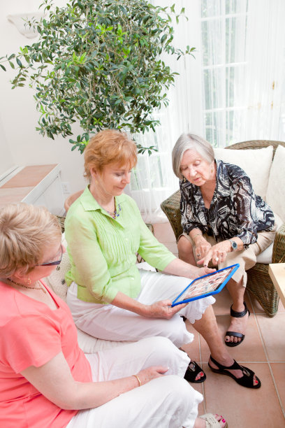 三位高级女性用平板电脑进行社交聚会图片下载