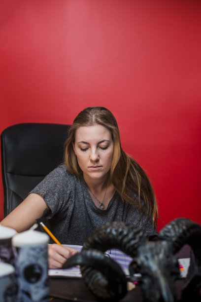 女纹身艺术家在餐桌上工作图片下载