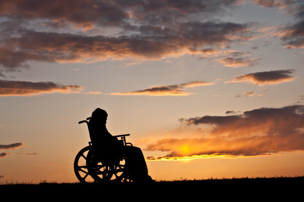 轮椅上受伤男孩的剪影图片下载
