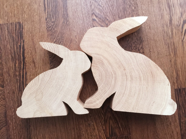 两个新鲜切割的diy橡木兔子在深色的木制背景上图片下载