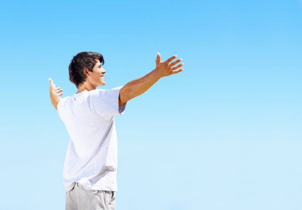 微笑着，双臂伸向蓝天图片下载