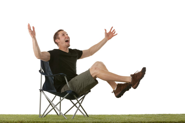 一个兴奋的男人坐在折叠椅上图片下载