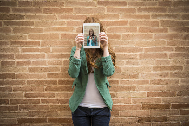 一个拿着平板电脑自拍的女人图片下载