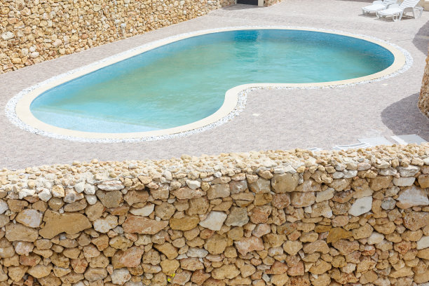 石头墙后的游泳池图片下载