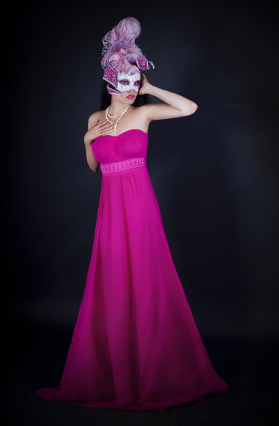 穿着粉色裙子，戴着威尼斯面具的性感女人图片下载